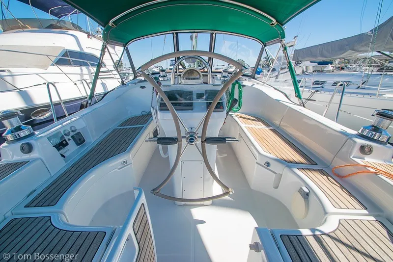 Slide: The Image of Cockpit of 2005 Beneteau Oceanis 423 sailboat with green canopy and wooden seating. - 35