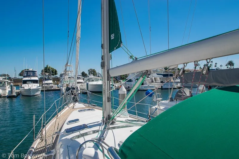 Slide: The Image of Sailboat Beneteau Oceanis 423, 2005 model, docked in a marina under clear blue skies. - 55