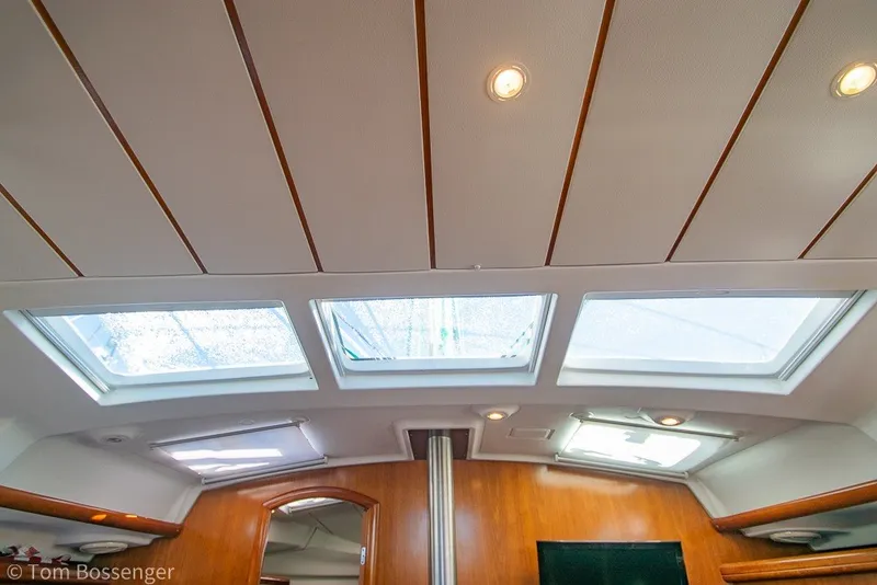Slide: The Image of Interior ceiling view of 2005 Beneteau Oceanis 423 sailboat with skylights and wood paneling. - 24