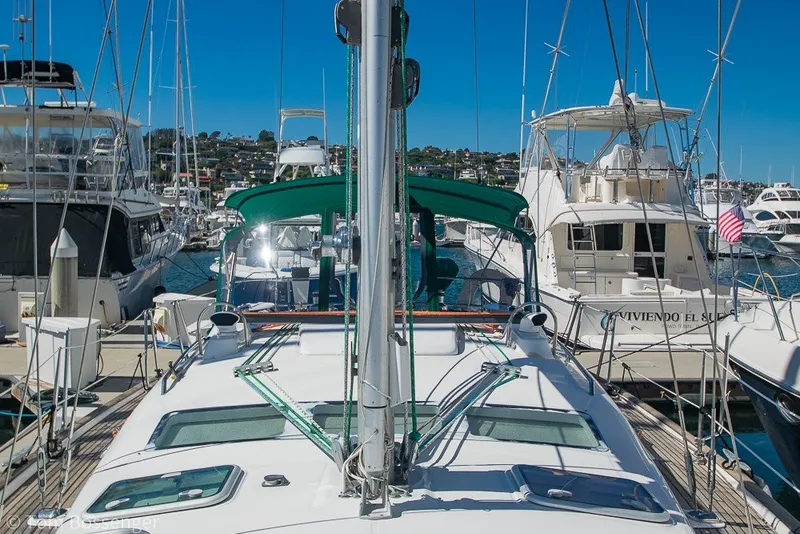 Slide: The Image of 2005 Beneteau Oceanis 423 sailboat docked in a marina under clear blue skies. - 63