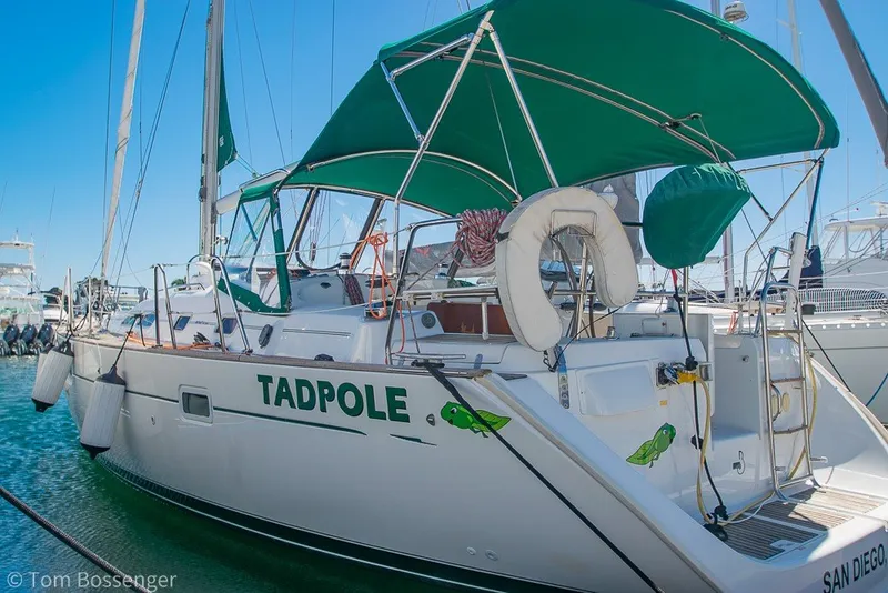 Slide: The Image of Beneteau Oceanis 423 sailboat, 2005 model, named "Tadpole," docked with green canopy. - 3