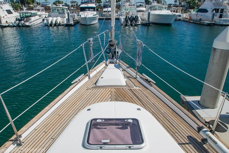 Slide: The Image of Deck view of a 2005 Beneteau Oceanis 423 sailboat docked in a marina. - 64