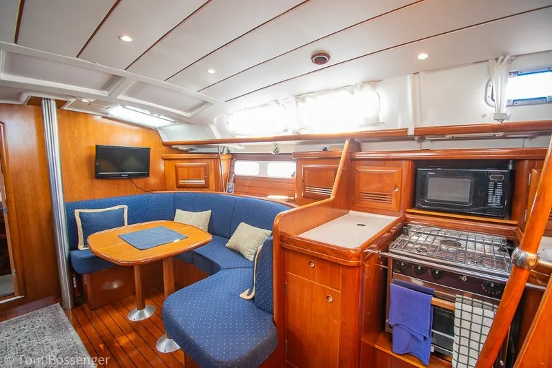 Slide: The Image of Interior of 2005 Beneteau Oceanis 423 yacht with cozy seating and kitchen area. - 11
