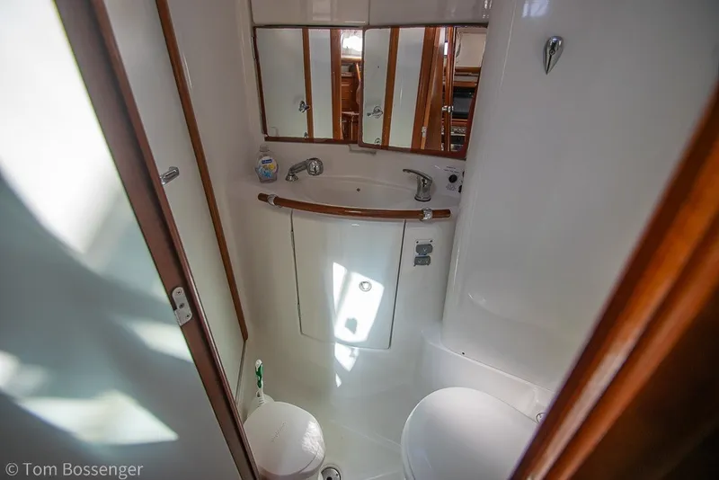 Slide: The Image of Compact bathroom in 2005 Beneteau Oceanis 423 yacht, featuring sink, mirror, and toilet. - 34