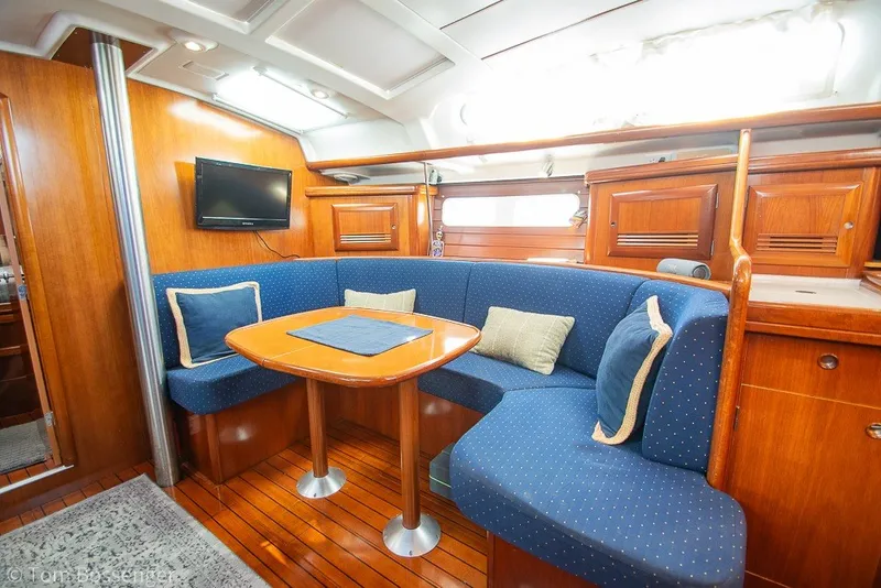 Slide: The Image of Interior of 2005 Beneteau Oceanis 423 yacht with cozy seating and wooden finishes. - 19