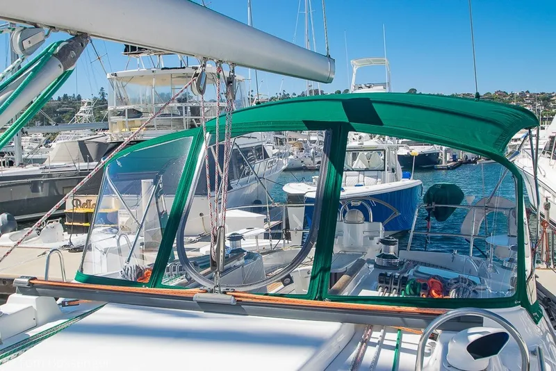 Slide: The Image of Sailboat Beneteau Oceanis 423, 2005 model, docked at marina with green canopy. - 60