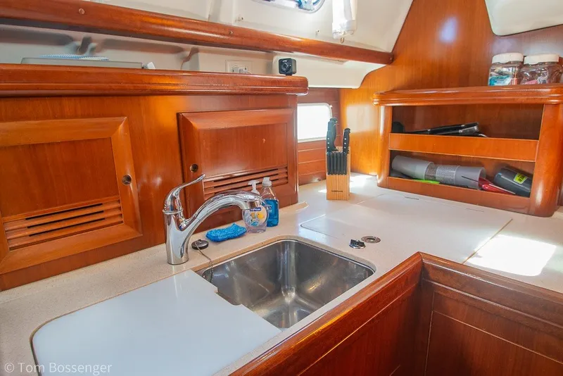 Slide: The Image of Galley of 2005 Beneteau Oceanis 423 sailboat with wooden cabinetry and stainless steel sink. - 16