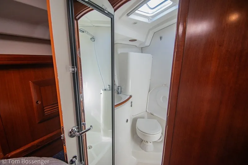 Slide: The Image of Bathroom interior of 2005 Beneteau Oceanis 423 yacht, featuring wooden accents and compact design. - 30
