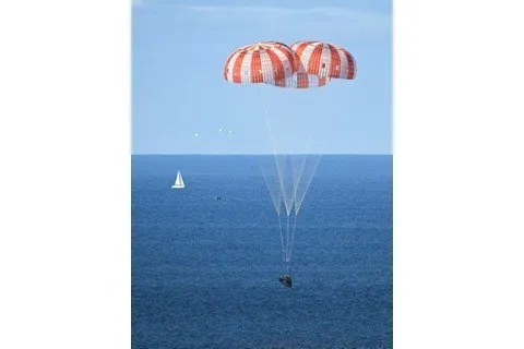 Slide: The Image of Parachutes descending over ocean with sailboat, Beneteau Oceanis 423, 2005 model. - 2
