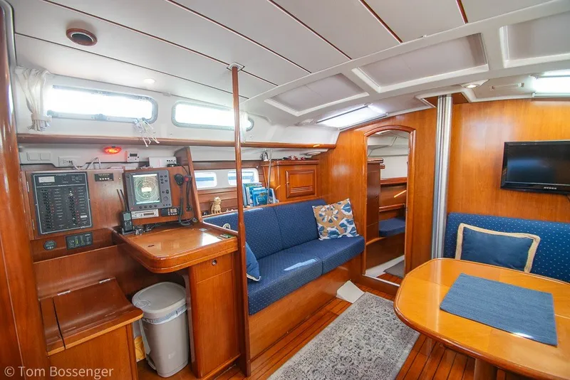 Slide: The Image of Interior of 2005 Beneteau Oceanis 423 yacht with wood finish and blue seating. - 12