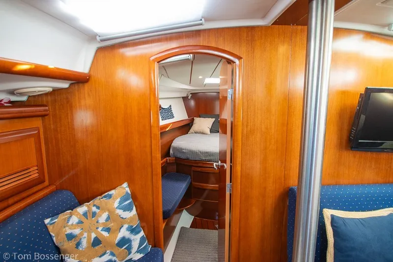 Slide: The Image of Interior of 2005 Beneteau Oceanis 423 yacht, featuring cozy cabin with wooden finish and seating. - 26