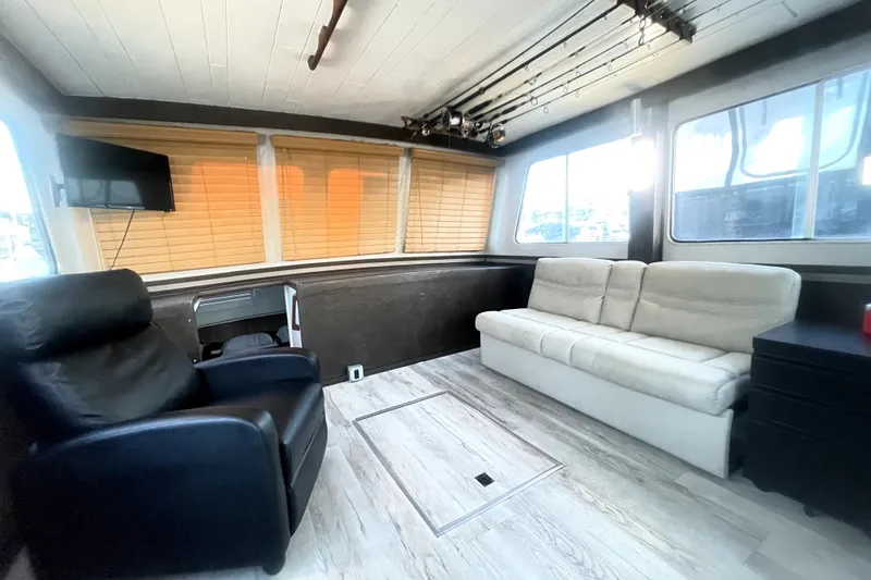 Slide: The Image of Interior of a 1978 Thompson motor yacht with modern seating and fishing rods. - 21