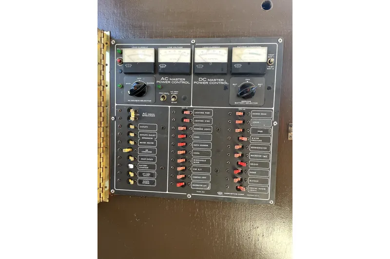 Slide: The Image of Electrical control panel on a 1978 Thompson motor yacht, featuring AC and DC power controls. - 19