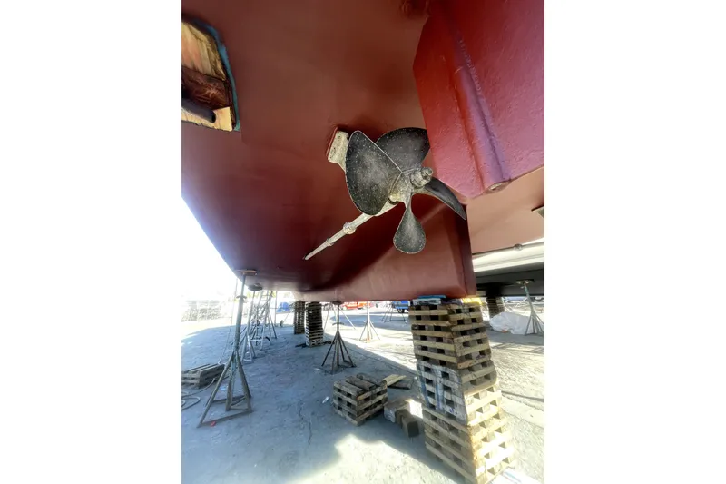 Slide: The Image of Underneath view of a 1978 Thompson motor yacht, showcasing the propeller and hull. - 33