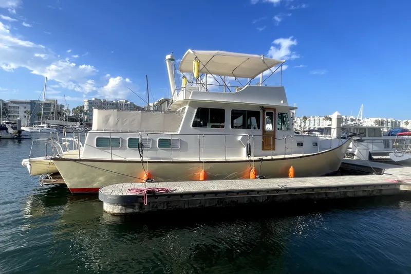 Slide: The Image of 1978 Thompson motor yacht docked at marina under clear blue sky. - 1
