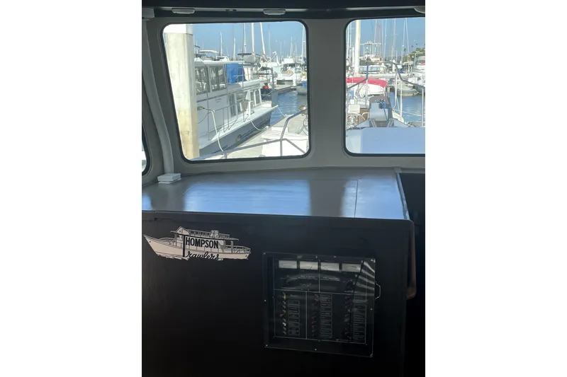 Slide: The Image of Interior view of a 1978 Thompson motor yacht, showcasing marina through windows. - 16