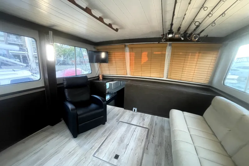 Slide: The Image of Interior of a 1978 Thompson motor yacht with modern seating and wooden blinds. - 20