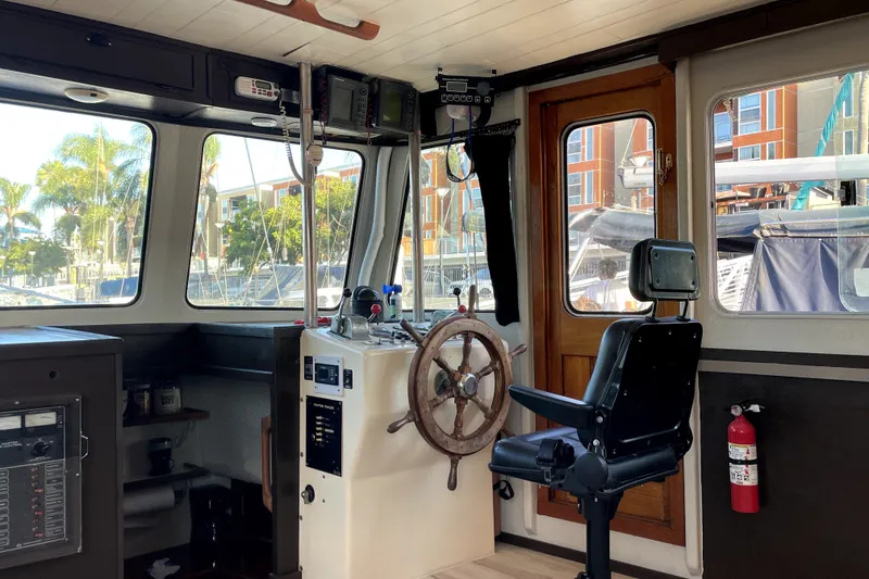 Slide: The Image of Interior of a 1978 Thompson motor yacht with steering wheel and control panel. - 18