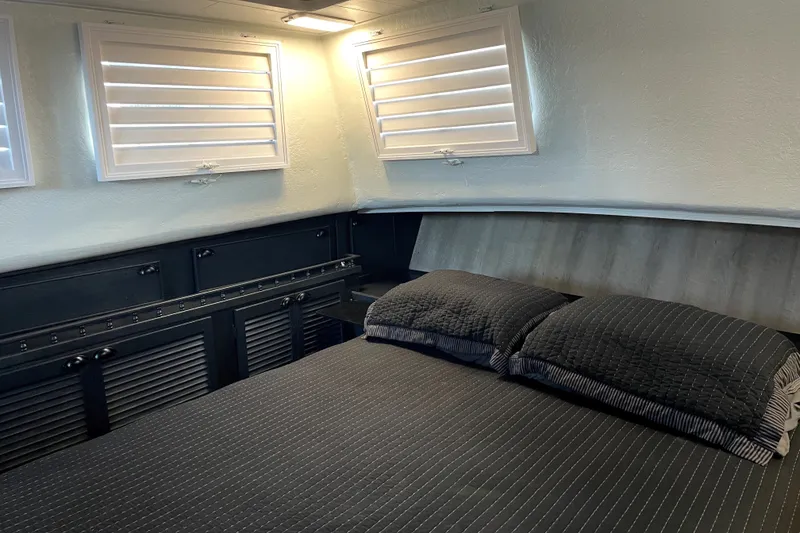 Slide: The Image of Cozy bedroom interior of a 1978 Thompson motor yacht with modern decor and soft lighting. - 25