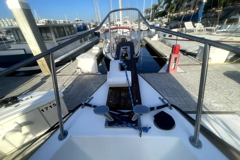 Slide: The Image of 1978 Thompson motor yacht docked at marina, view from bow with clear blue sky. - 23