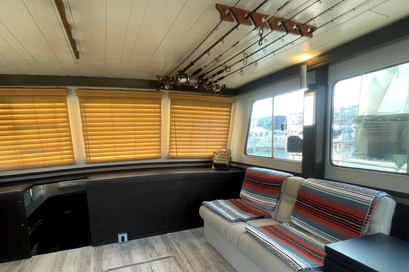 Slide: The Image of Interior of a 1978 Thompson motor yacht with striped seating and fishing rods. - 27