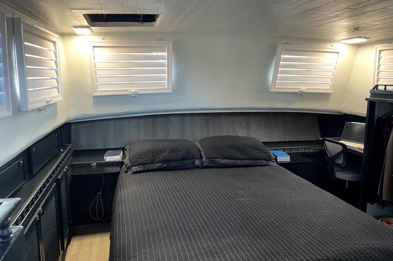 Slide: The Image of Cozy bedroom interior of a 1978 Thompson motor yacht with modern furnishings. - 26