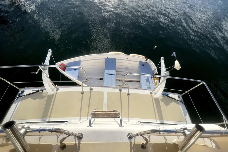 Slide: The Image of 1978 Thompson motor yacht deck with railing, overlooking calm water. - 3