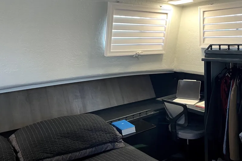 Slide: The Image of Cozy cabin interior of a 1978 Thompson motor yacht with bed, desk, and laptop. - 24