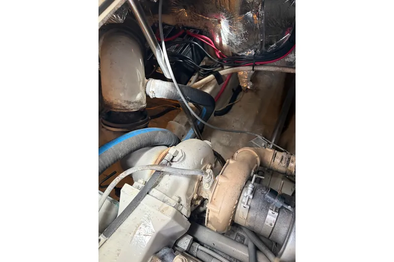 Slide: The Image of Engine compartment of a 2000 Albin 35 Tournament Express boat, showing hoses and components. - 46