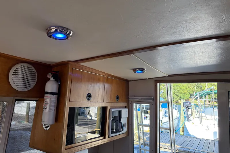 Slide: The Image of Interior of 2000 Albin 35 Tournament Express with blue LED lights and wooden cabinetry. - 38
