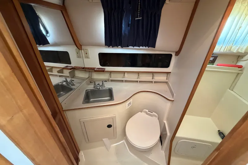 Slide: The Image of 2000 Albin 35 Tournament Express bathroom with sink, toilet, and mirror. - 24