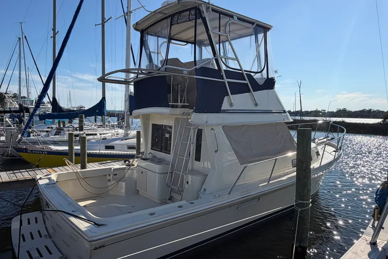 The Image of 2000 Albin 35 Tournament Express boat docked at marina under clear blue sky. - 0