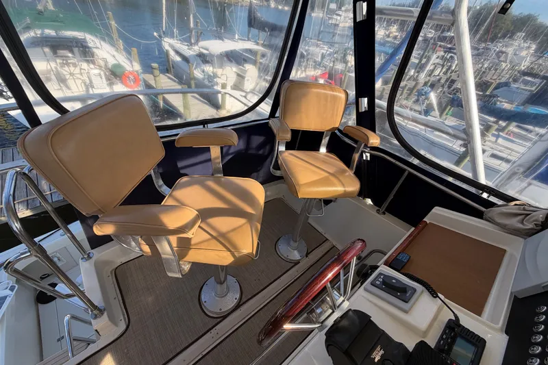 Slide: The Image of Interior of a 2000 Albin 35 Tournament Express boat with tan captain chairs. - 65
