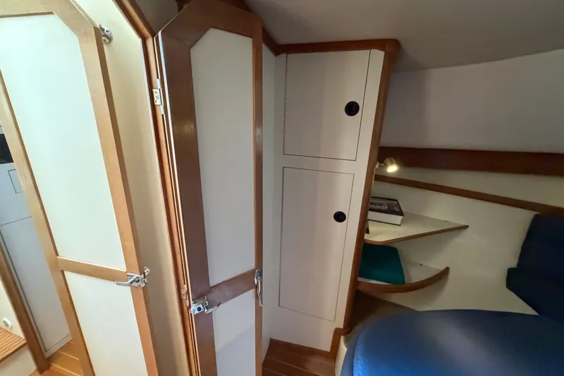 Slide: The Image of Interior of 2000 Albin 35 Tournament Express, featuring wooden cabinetry and cozy seating area. - 23