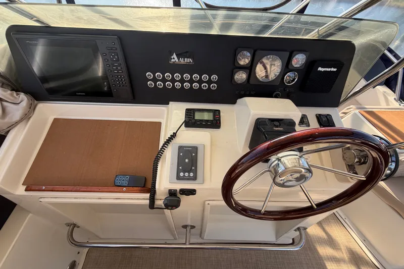 Slide: The Image of Helm of 2000 Albin 35 Tournament Express with steering wheel and navigation instruments. - 48