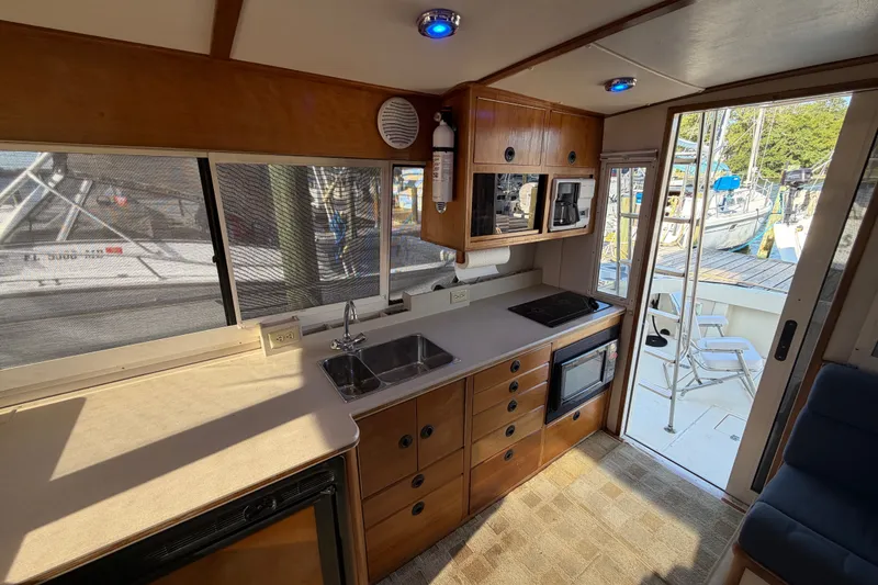 Slide: The Image of Interior of 2000 Albin 35 Tournament Express boat with kitchen and dock view. - 32