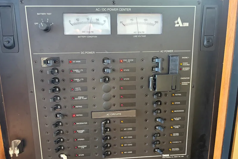 Slide: The Image of Electrical panel of a 2000 Albin 35 Tournament Express boat, showing AC/DC power controls. - 18