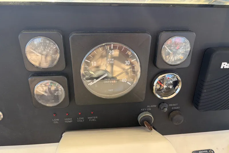 Slide: The Image of Dashboard of a 2000 Albin 35 Tournament Express boat with various gauges and controls. - 50