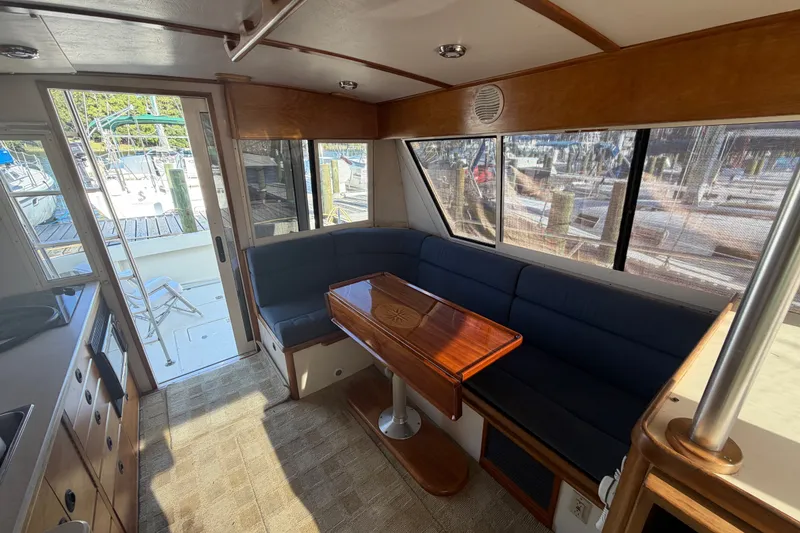 Slide: The Image of Interior of 2000 Albin 35 Tournament Express with seating and table, dock view. - 14