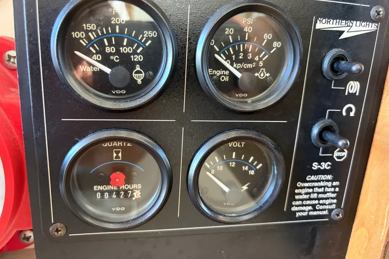 Slide: The Image of Instrument panel of a 2000 Albin 35 Tournament Express boat showing gauges and switches. - 16