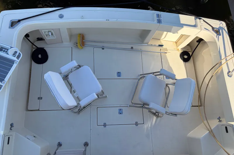 Slide: The Image of 2000 Albin 35 Tournament Express boat deck with chairs and cleaning tools. - 62