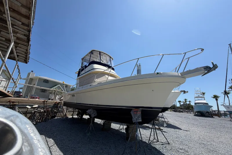 Slide: The Image of 2000 Albin 35 Tournament Express boat on dry dock under clear blue sky. - 70