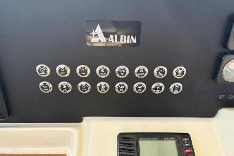 Slide: The Image of Control panel of a 2000 Albin 35 Tournament Express boat with labeled switches. - 49