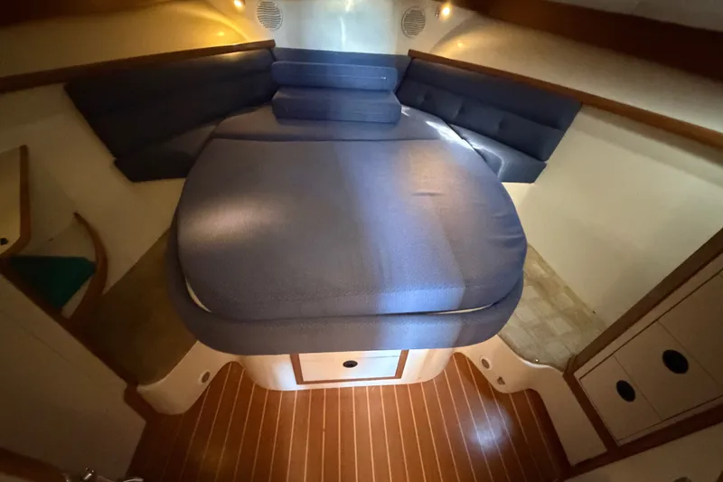 Slide: The Image of Interior cabin of 2000 Albin 35 Tournament Express with cozy blue seating and wood flooring. - 21