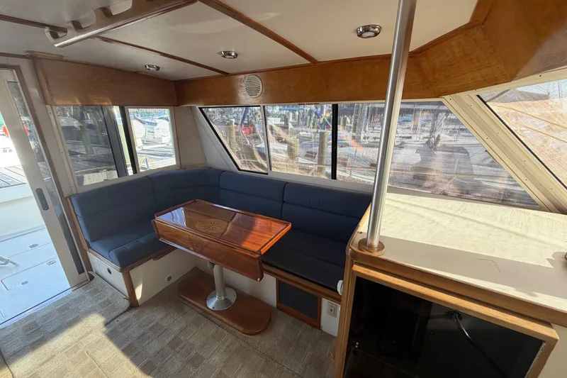 Slide: The Image of Interior of 2000 Albin 35 Tournament Express with blue seating and wooden table. - 13
