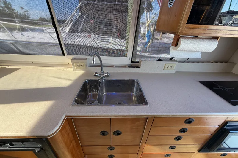 Slide: The Image of Interior view of 2000 Albin 35 Tournament Express kitchen with sink and wooden cabinets. - 28