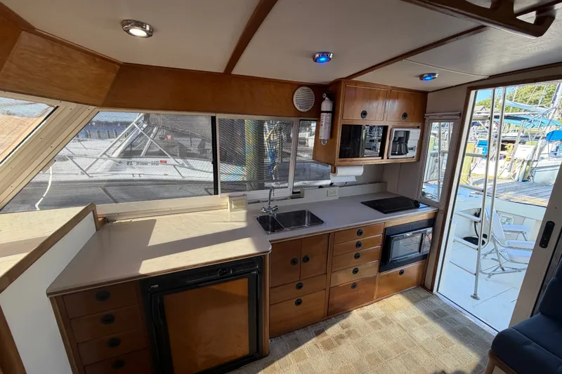 Slide: The Image of Interior of 2000 Albin 35 Tournament Express boat with kitchen amenities. - 33
