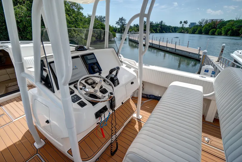 Slide: The Image of 2008 Intrepid 370 Cuddy boat helm with modern controls, dockside view. - 12