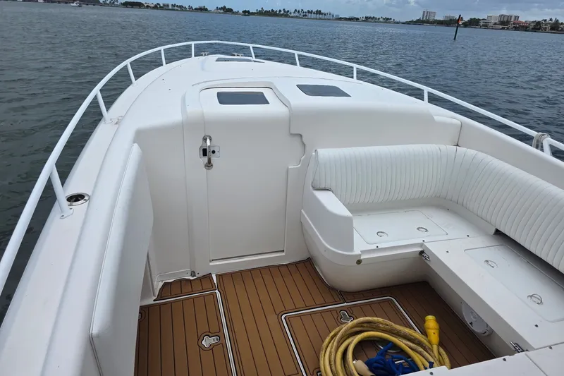 Slide: The Image of 2008 Intrepid 370 Cuddy boat interior with seating and deck view. - 6