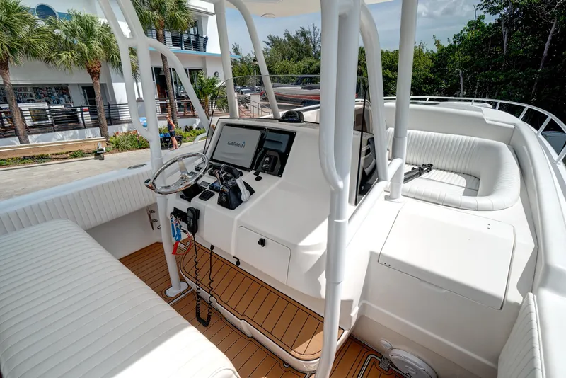 Slide: The Image of 2008 Intrepid 370 Cuddy boat cockpit with Garmin navigation system and white seating. - 26